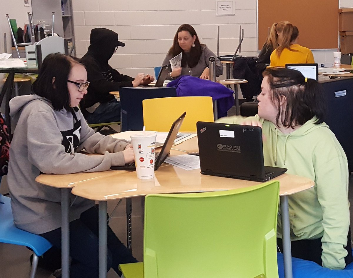 American 2 students working together to analyze primary photos about problems during the Gilded Age. <a href="/BCSCommunityHS/">Community HS</a>