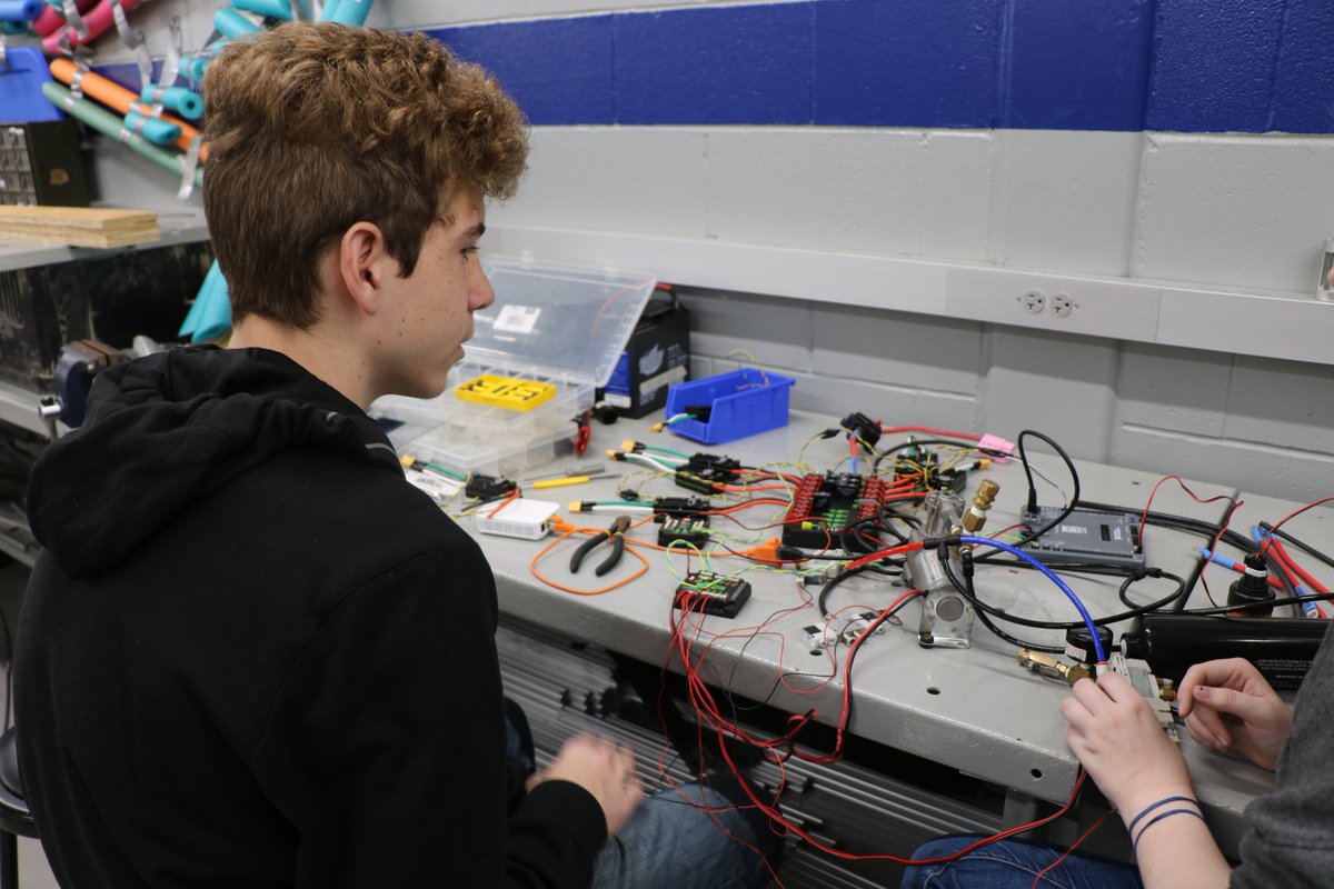 Maddie teaching Skylor about electronics and how to connect the wires