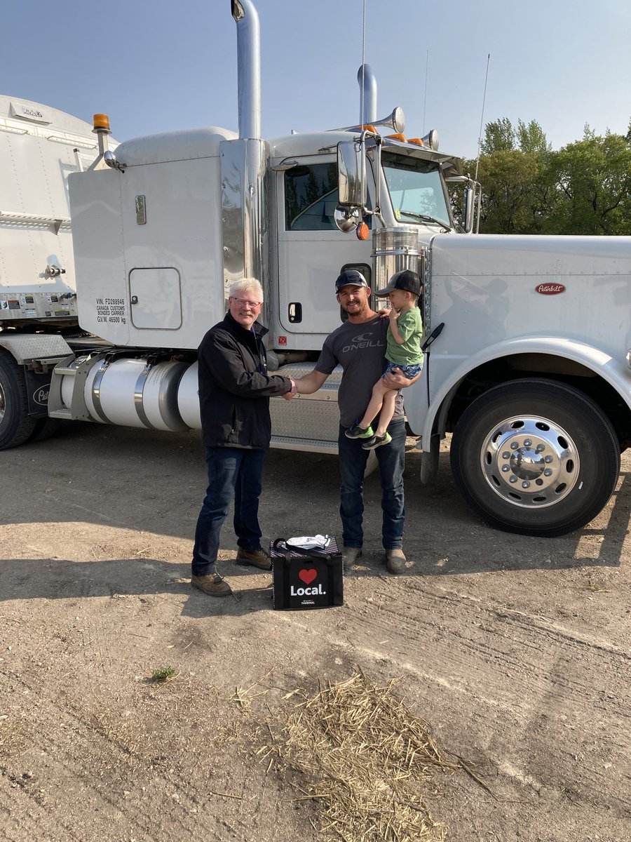 Darren Baril wins a meal in the field from AGI. Prairie North Coop manager Dave Nienaber presented him with cooler full of food.
