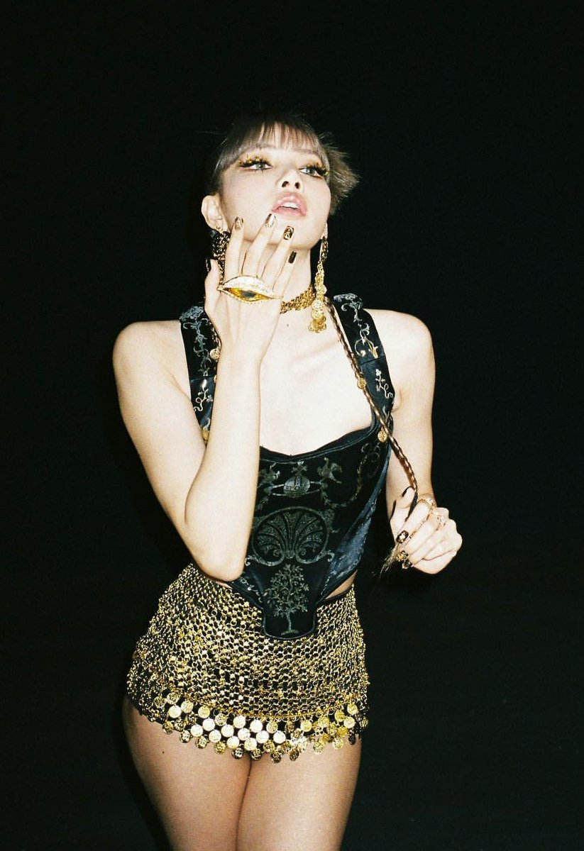 LISA wearing a vintage black satin corset top with metallic gold