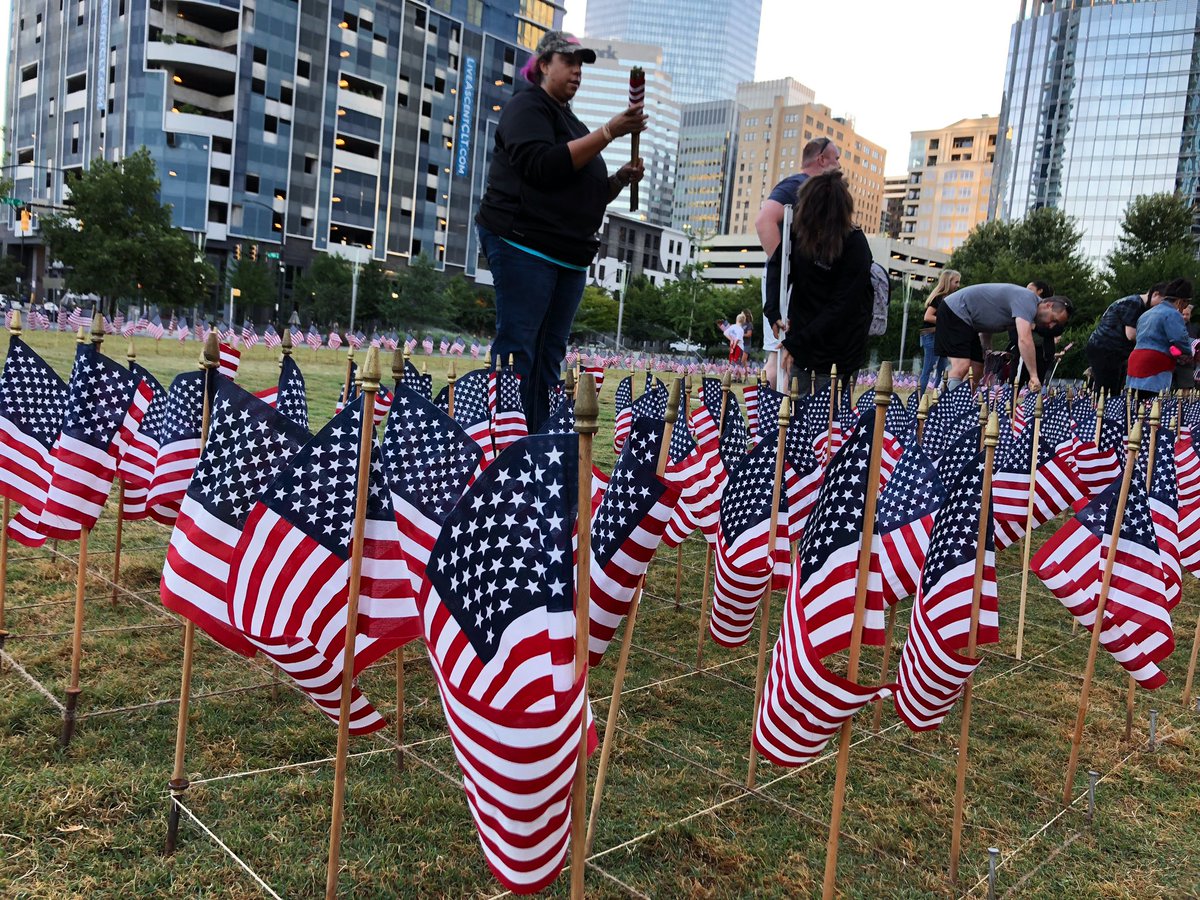 WCCBCharlotte's tweet photo. Volunteers are at Romare Bearden Park putting 2,977 American flags into the ground in the shape of the twin towers. Each will have the name and picture of a person lost that day. The #flagsofremembrance will be on display till Monday. #September11 https://t.co/KMomW1eDlU