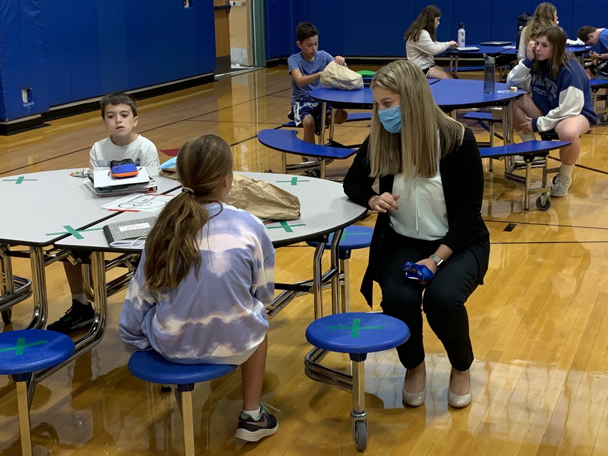Middle school principal, Karolyn Rodriguez,  chats with students at lunch