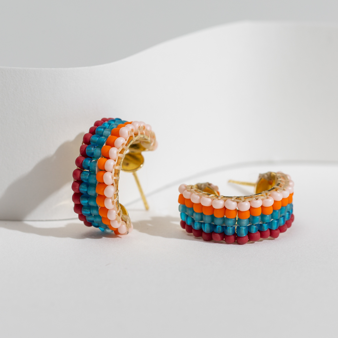One word: groovy. 🕺
⠀⁠
Inspired by '70s fashion and today's graphic stripes trend, these cuff earrings are made in Haiti with glass beads. Shop your pair of the Groovy Hoops: