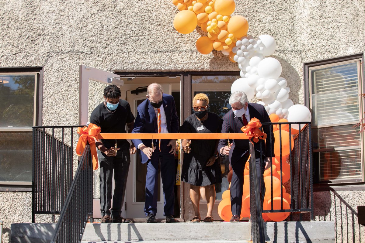 Members of the campus community, including Chancellor Kent Syverud, cutting the ribbon for the grand opening of 119 Euclid Ave