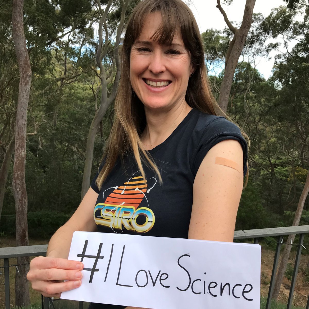 A lady holding a sign saying #ILoveScience