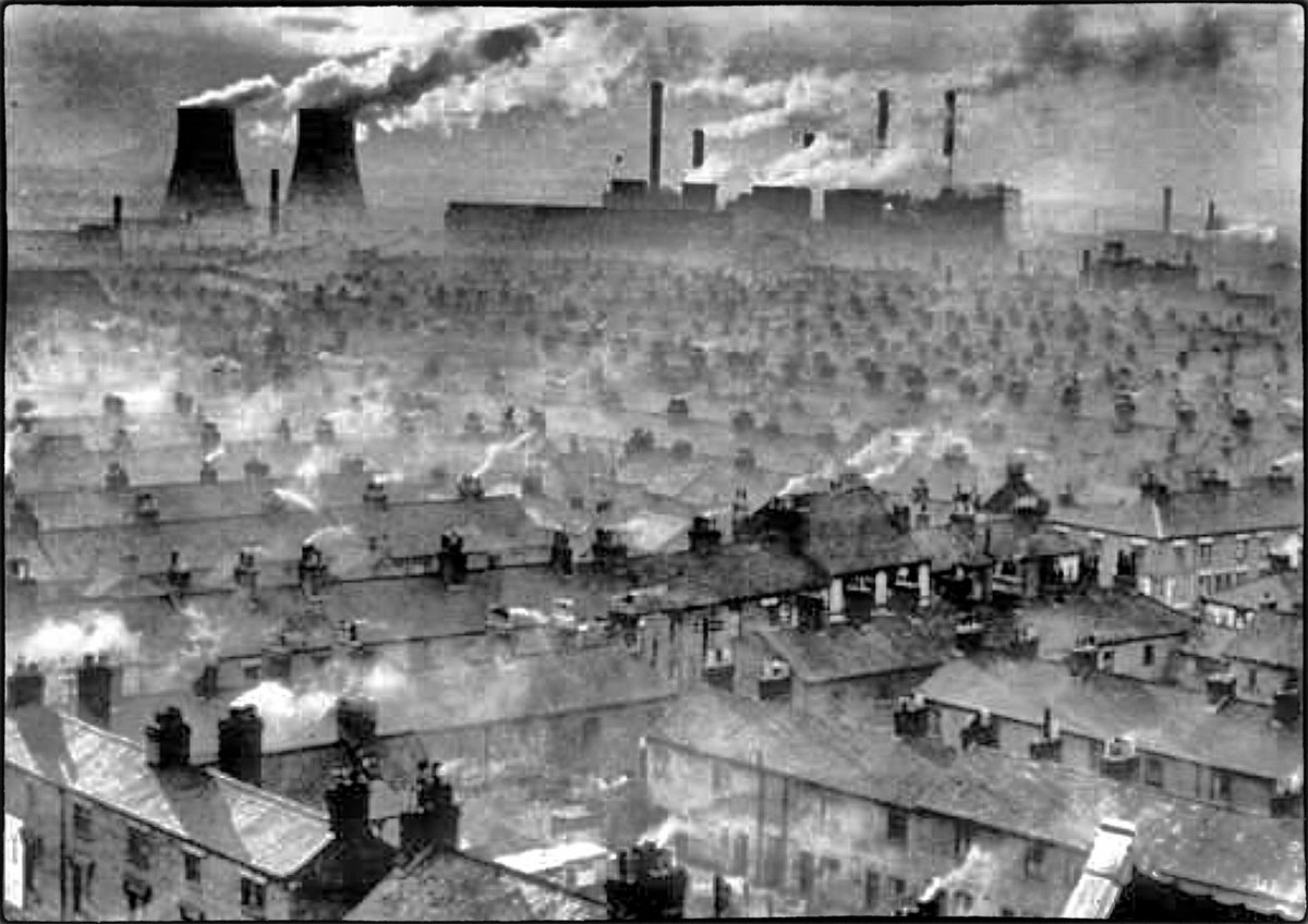 A rather 'cheerful' looking #Wigan from the 1930s. With not only the vast terraced housing belching out muck, but the local Westwood power station contributing to the not so clean air act of the time. <a href="/GrimArtGroup/">Grim Art</a> #smog