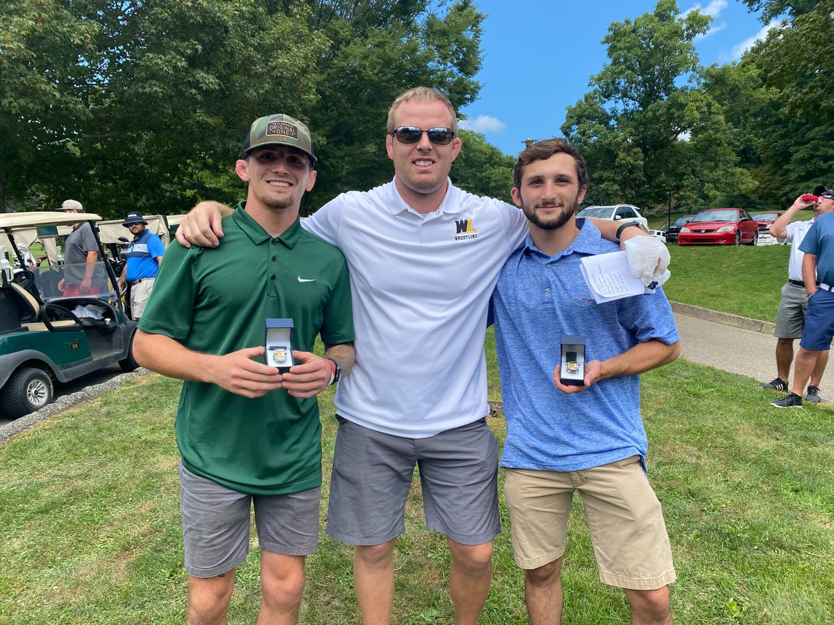 WestLibertyU's tweet photo. Coach Danny Irwin with his two National Champs displaying their rings, 133-pounder Tyler Warner and 125-pounder Cole Laya at Saturday's golf outing. So proud of our wrestlers! #GoWLU #ClimbTheHill https://t.co/ozsRYIIMR1
