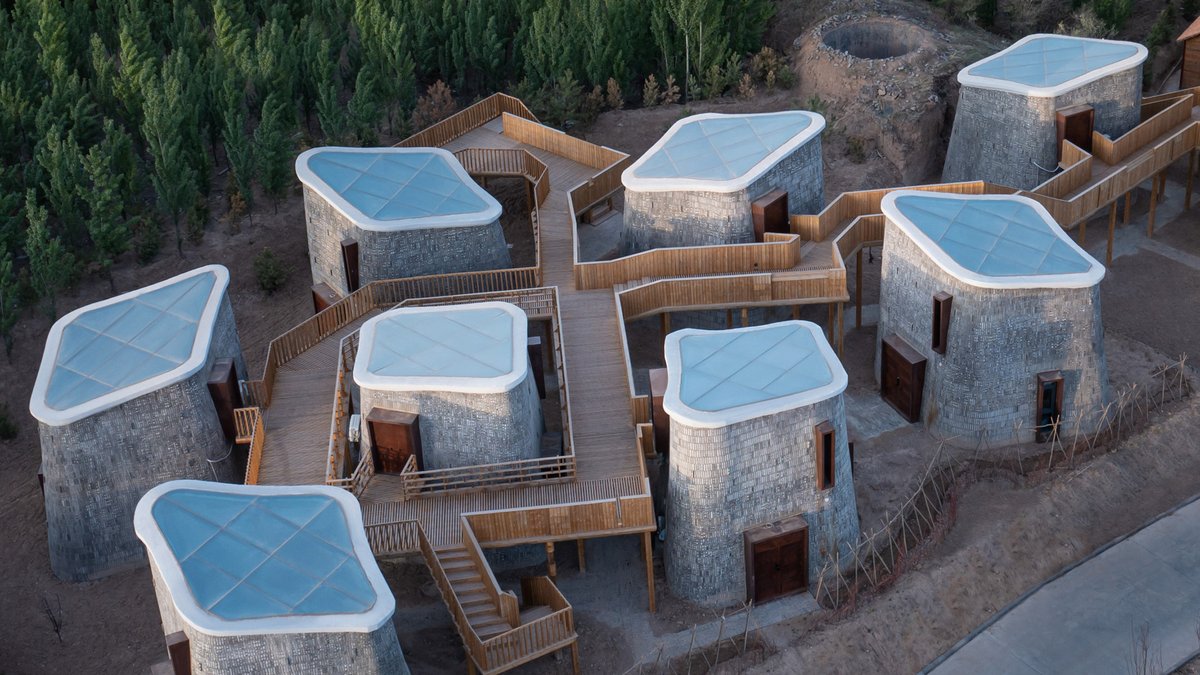 Studio Avoid has completed a retreat in China's Hebei province comprising a series of cave-like brick-clad pods connected by a raised walkway. #architecture #interiordesign #design #China