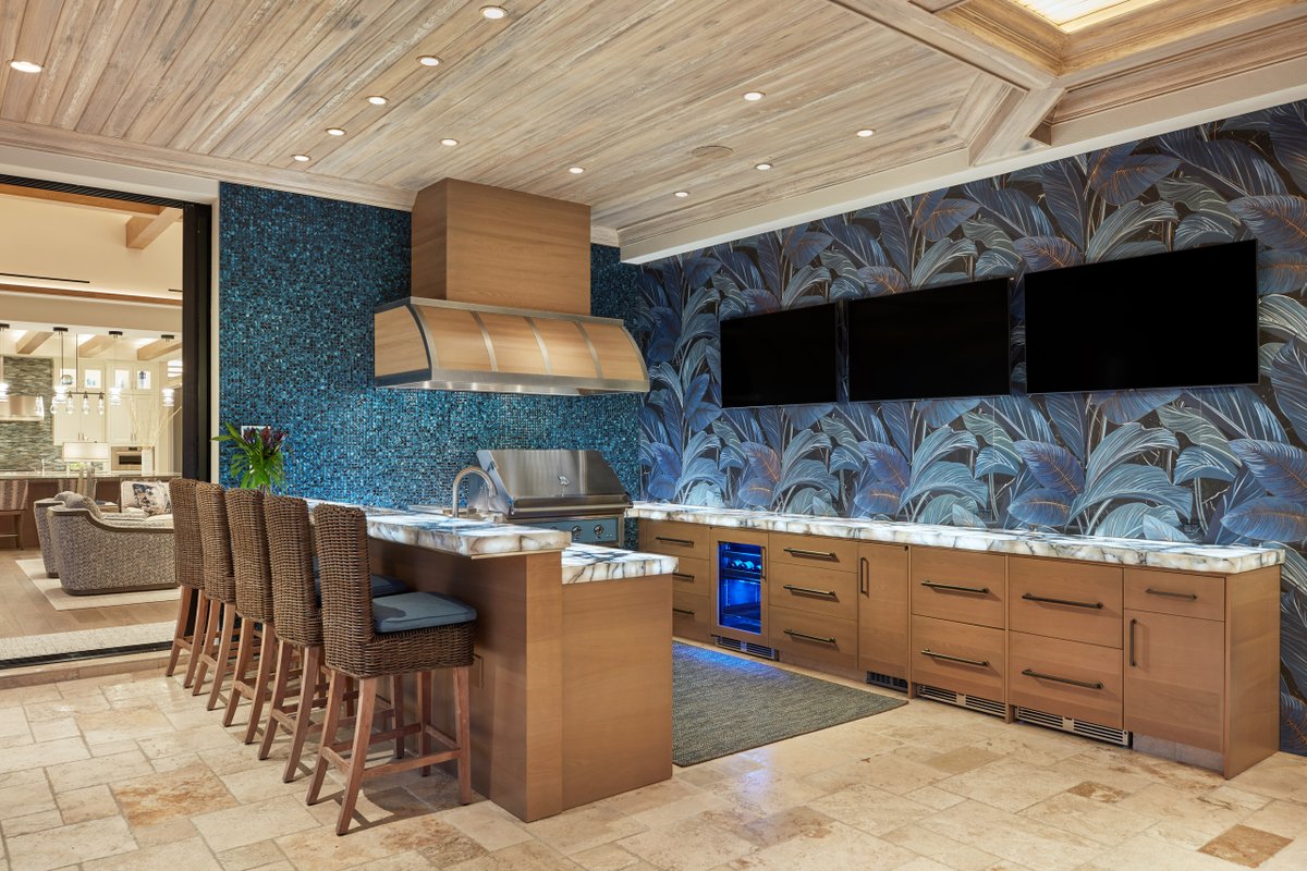 collins_dupont's tweet image. The blue mosaic and palm-frond-tiled walls, cypress ceiling and light wood cabinetry carry the natural appeal of the interior spaces to the outdoor kitchen, boasting multiple televisions and ample space for entertaining guests. Read more at ecs.page.link/LFWVo