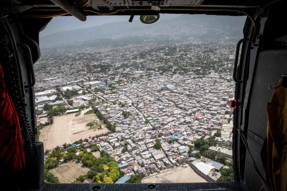 Haitians gather in Saint-Louis-du-Sud, Haiti as an MH-60S #SeaHawk helicopter, attached to the #Snowmen of Helicopter Sea Combat Squadron #HSC28, delivers humanitarian aid. HSC 28 is operating from the amphibious transport dock ship USS Arlington #LPD24. #Haitiearthquake2021