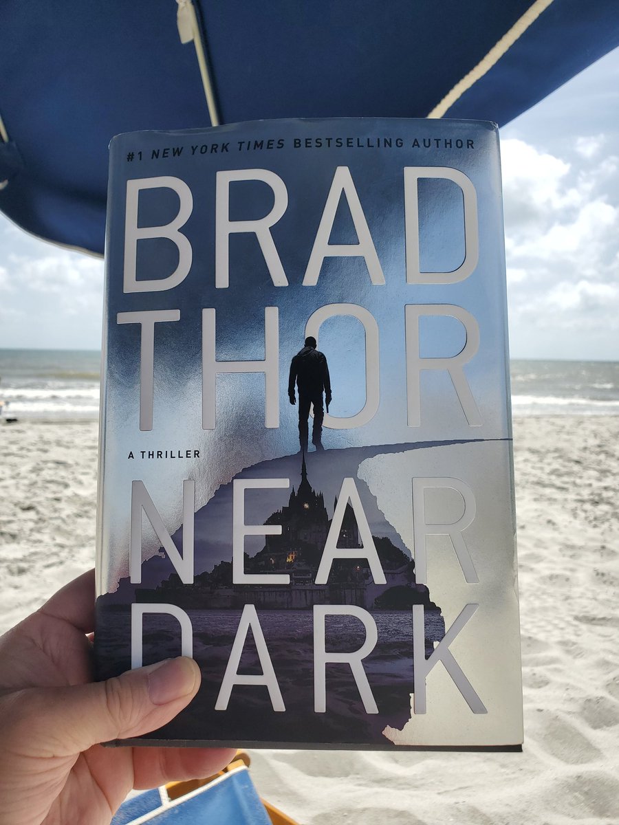 Reading 'Near Dark' by @BradThor. #beachreading #thriller