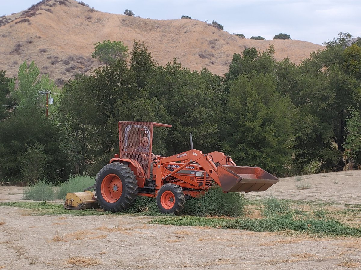Tractor mowing green Tumbleweeds