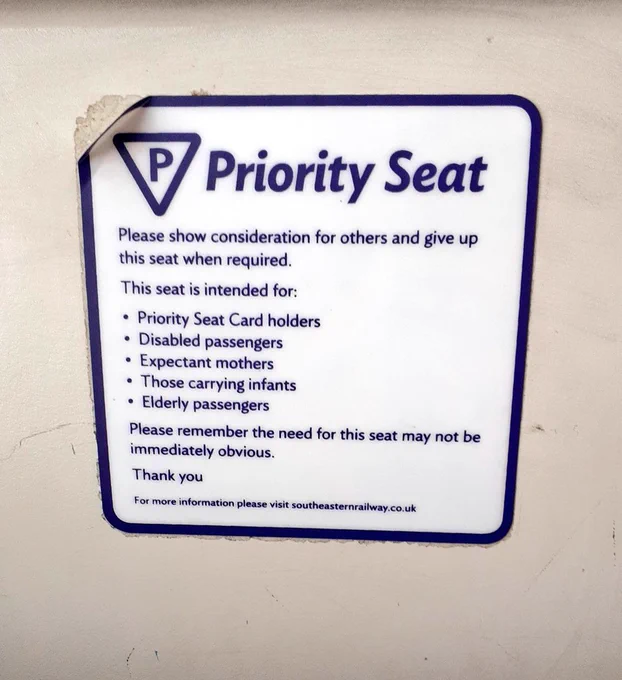 Train priority seat sight explaining who might need to sit and that the need might not be visible