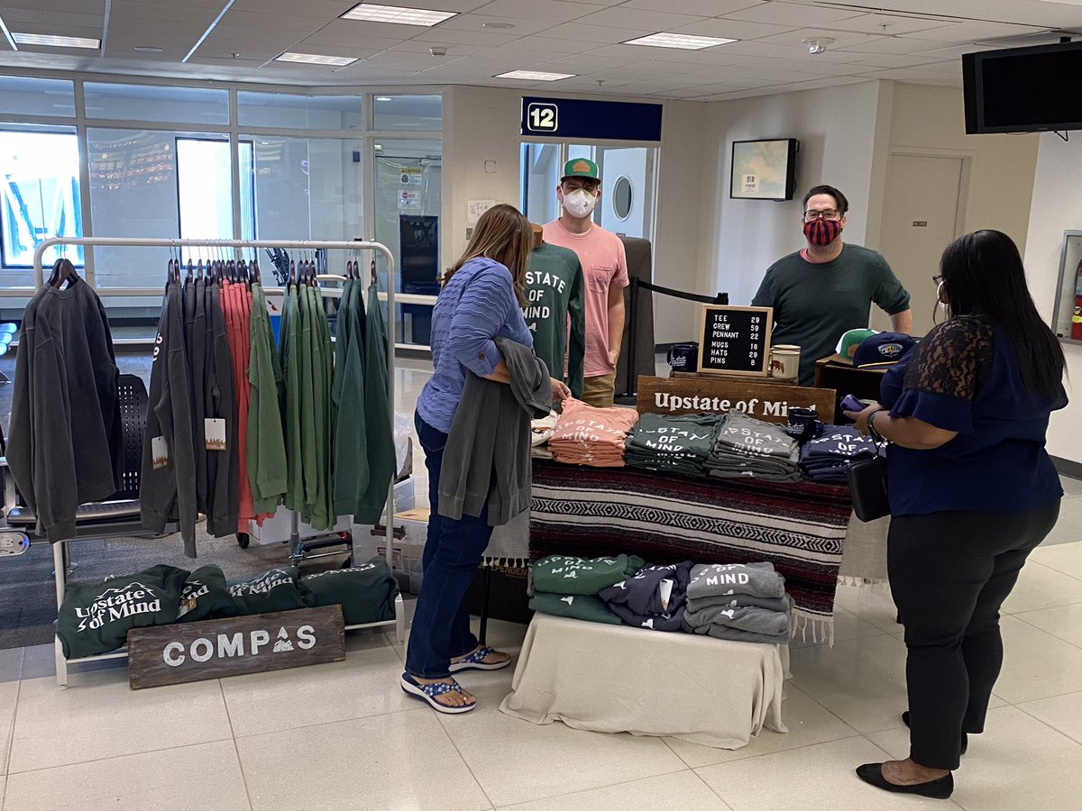 SyracuseAirport's tweet photo. 👕HAPPENING NOW👕
The @Compaslife pop up booth is active at SYR until 2pm! Check them out in Terminal A near Heritage Booksellers. Not traveling today? No worries - you can grab your #UpstateofMind swag anytime moving forward at our @PLshopdinefly gift shops! ✈️💯🙌🏼
#airport https://t.co/I2lXuq8L7P