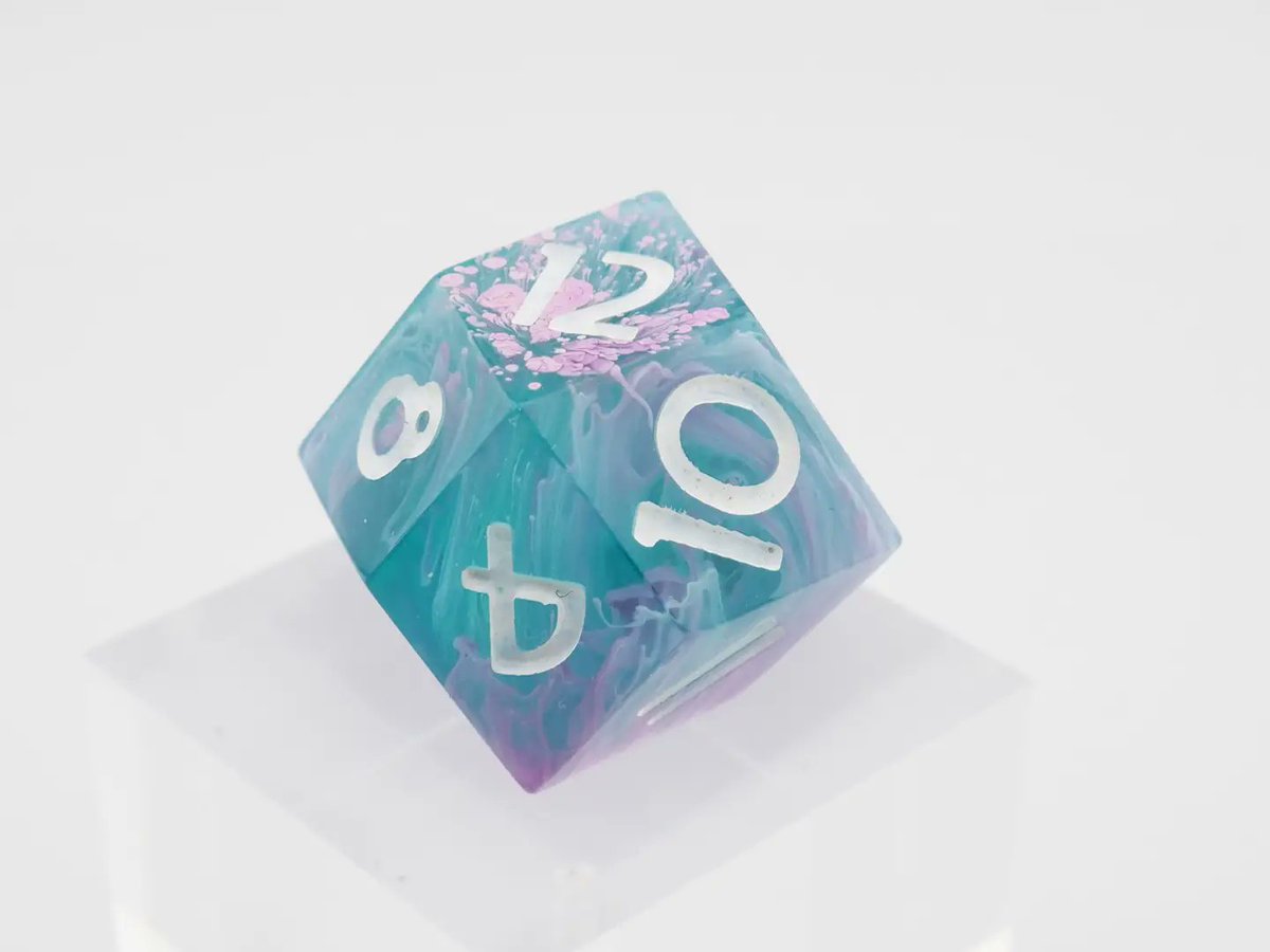 CatInTheDiceBag's tweet photo. This #diceset is a redo on the #coral #reef set. Its made with the #petridish effect. Some clear blue resin with #pink effects, which looks like pink corals in a #coralreef. 
(Ad)
#dice #dnd #handmadedice #epoxy #resin #dnd5e #rpg #ttrpg #würfel #d20 https://t.co/qZV5xlUuC0