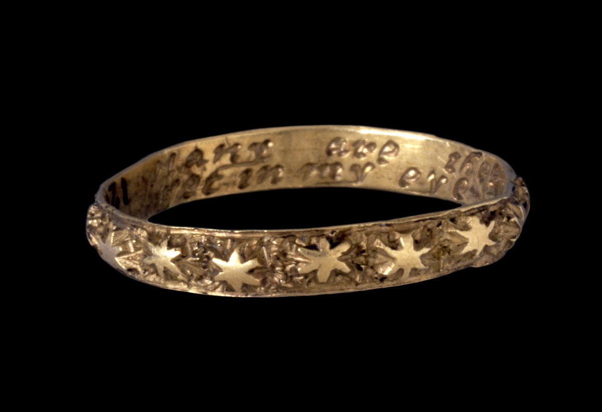 gold ring covered in stars from the 1700s with the inscription 'many are the stars i see yet in my eye no star like thee.'