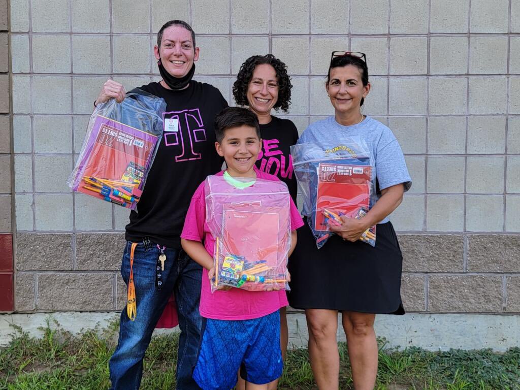 PlanteTanya's tweet photo. Erica from our Waterford CT store with the principal of Springbrook Elementary in Westerly RI handing out school supplies to children and families who need them. Giving back to our small and rural communities one good deed at a time! #SMRA #magenta #BackToSchool #NewEngland https://t.co/OV7bmVShGo