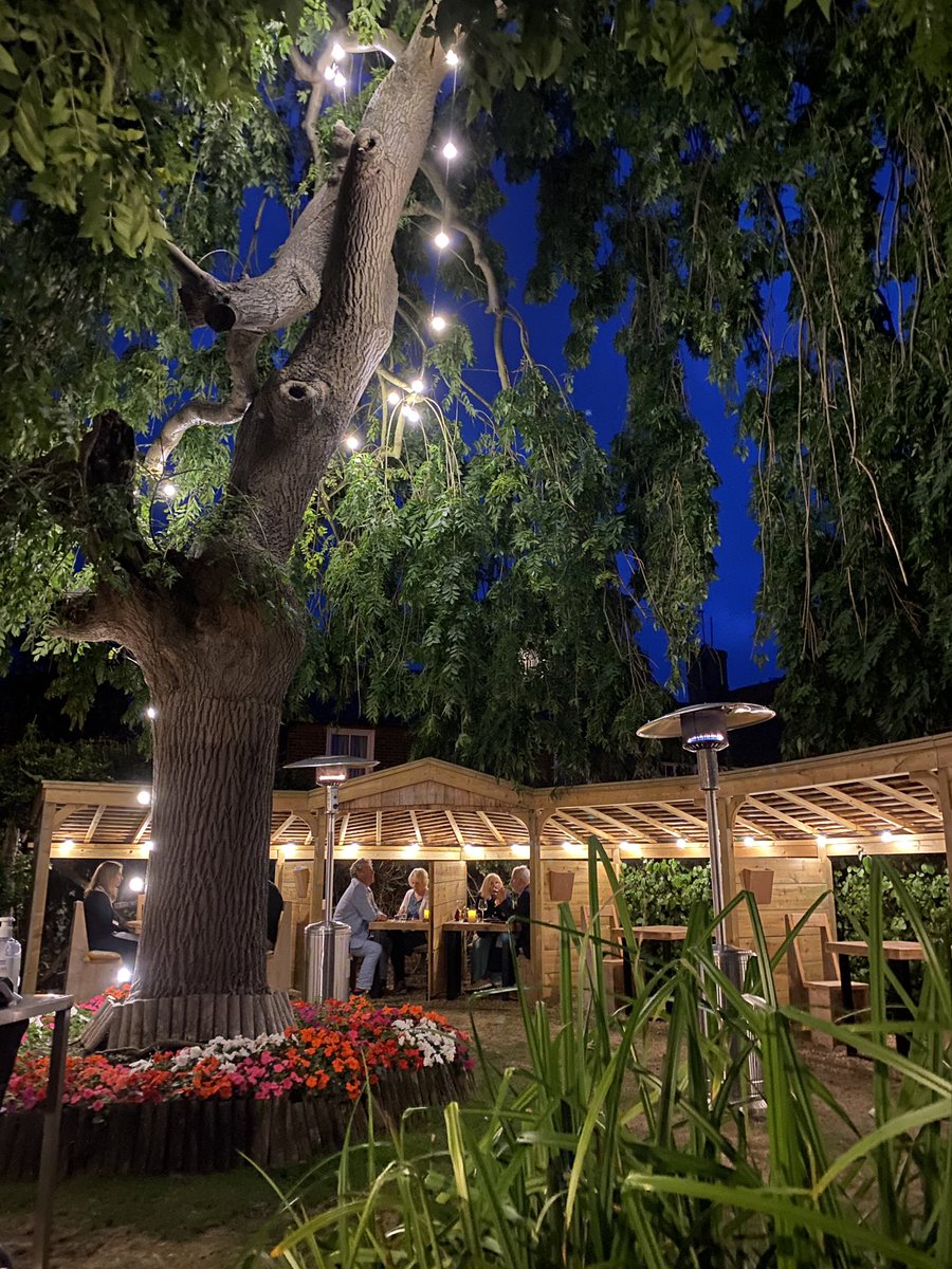 The garden dining area looks lovely this evening