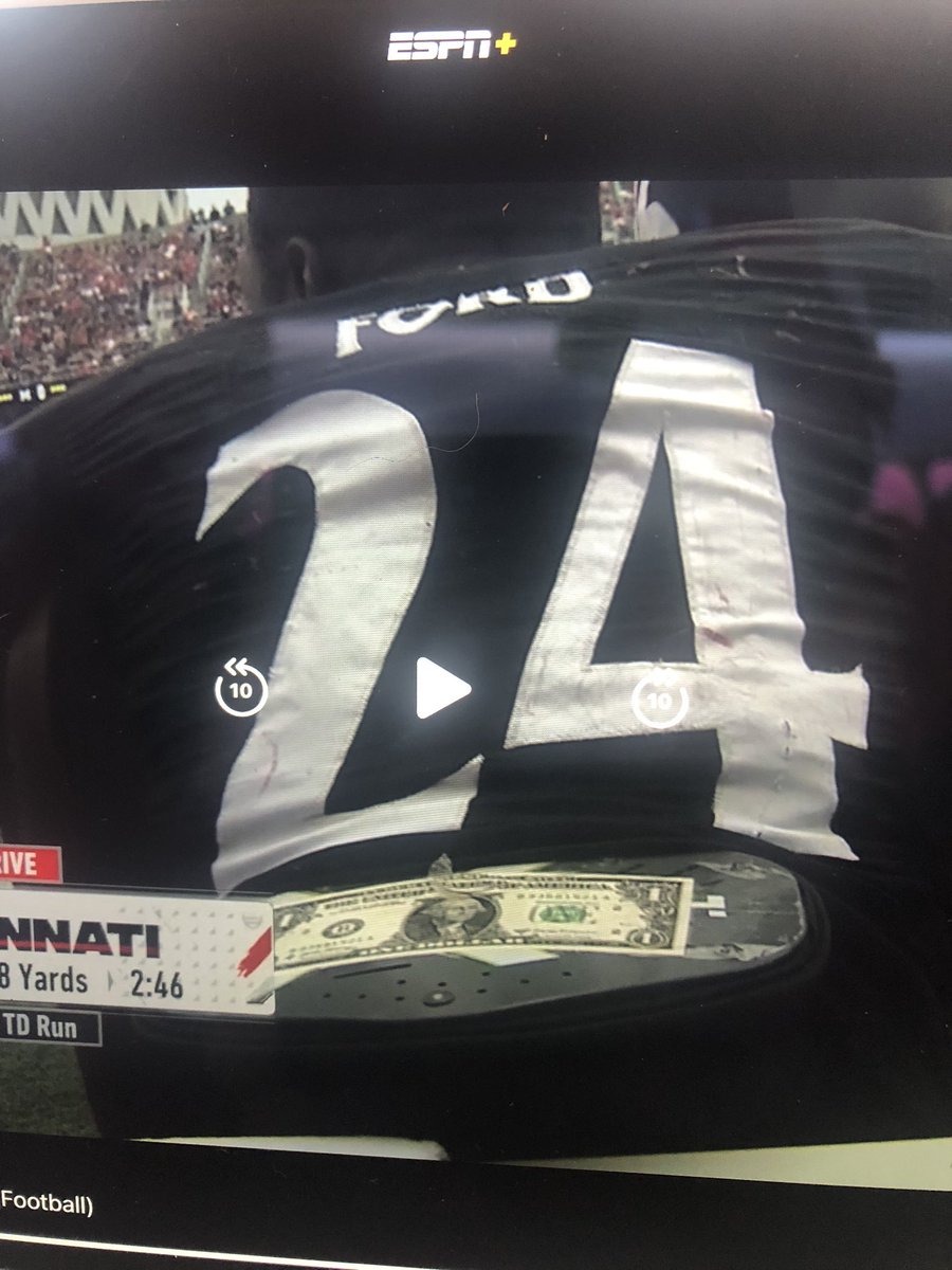 UnnecRoughness's tweet photo. Cincinnati’s Jerome Ford plays with a dollar bill attached to his pads. https://t.co/rL42fwjqhk