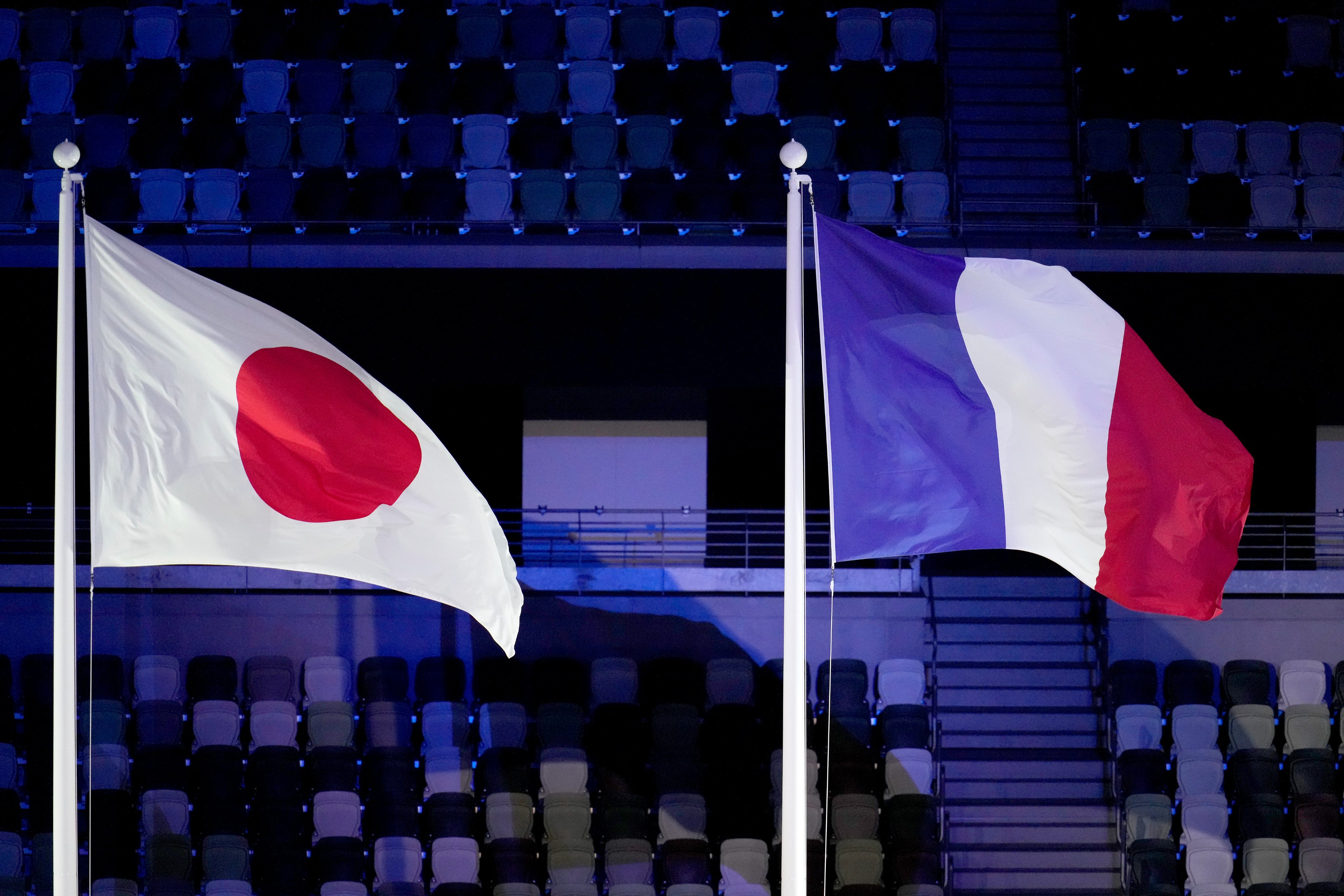 The japan and france flag fly in the staidum