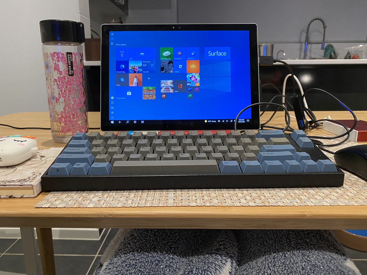 Microsoft surface hooked up to keyboard, mouse etc on a dining table