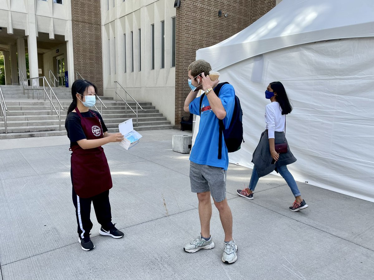McMasterU's tweet image. Eva from @maccampusstore hands out masks to students on the first day of classes. Thanks, Eva! #BackToMac
