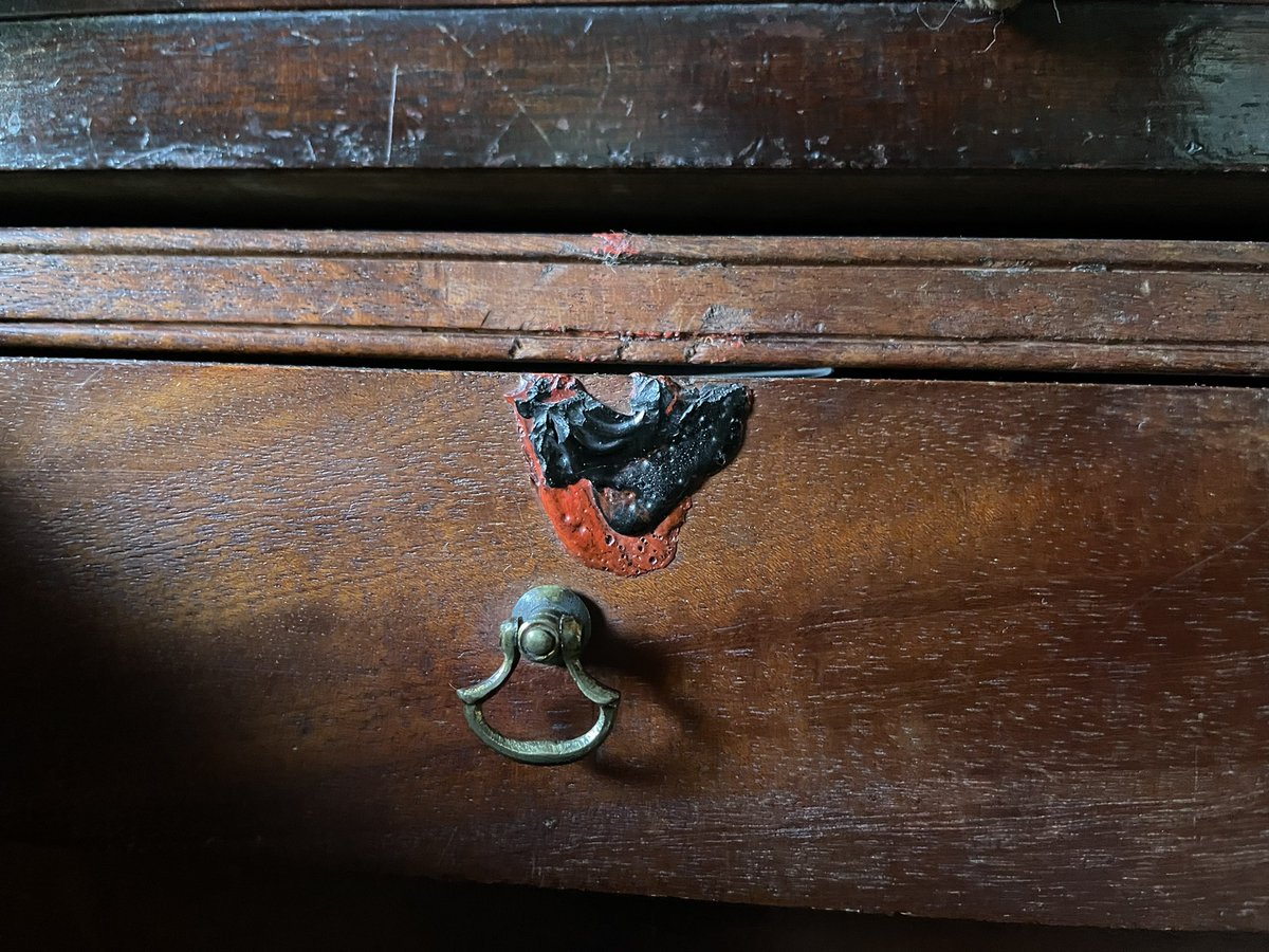 Remains of sealing wax on the drawer of a campaign desk. Presumably the drawer itself would be sealed during transit so that any tampering would be evident?