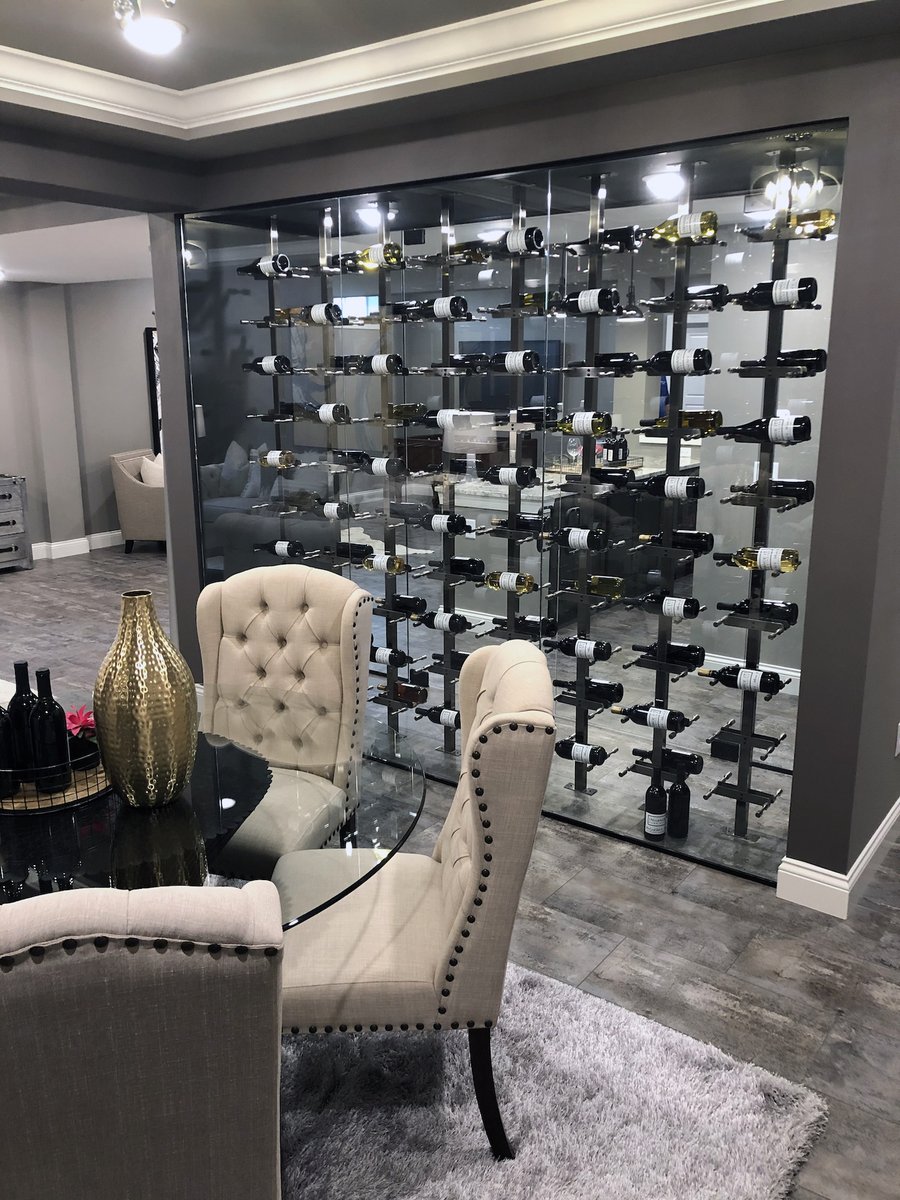 By using a VintageView Post system,  wall-mounted wine racks can transform into creative room dividing solutions Like this wine display built by  <a href="/PayneFamilyHome/">Payne Family Homes</a>. Vino Series Posts enclosed in glass create a see-through wine display that incorporates nicely into the open layout.