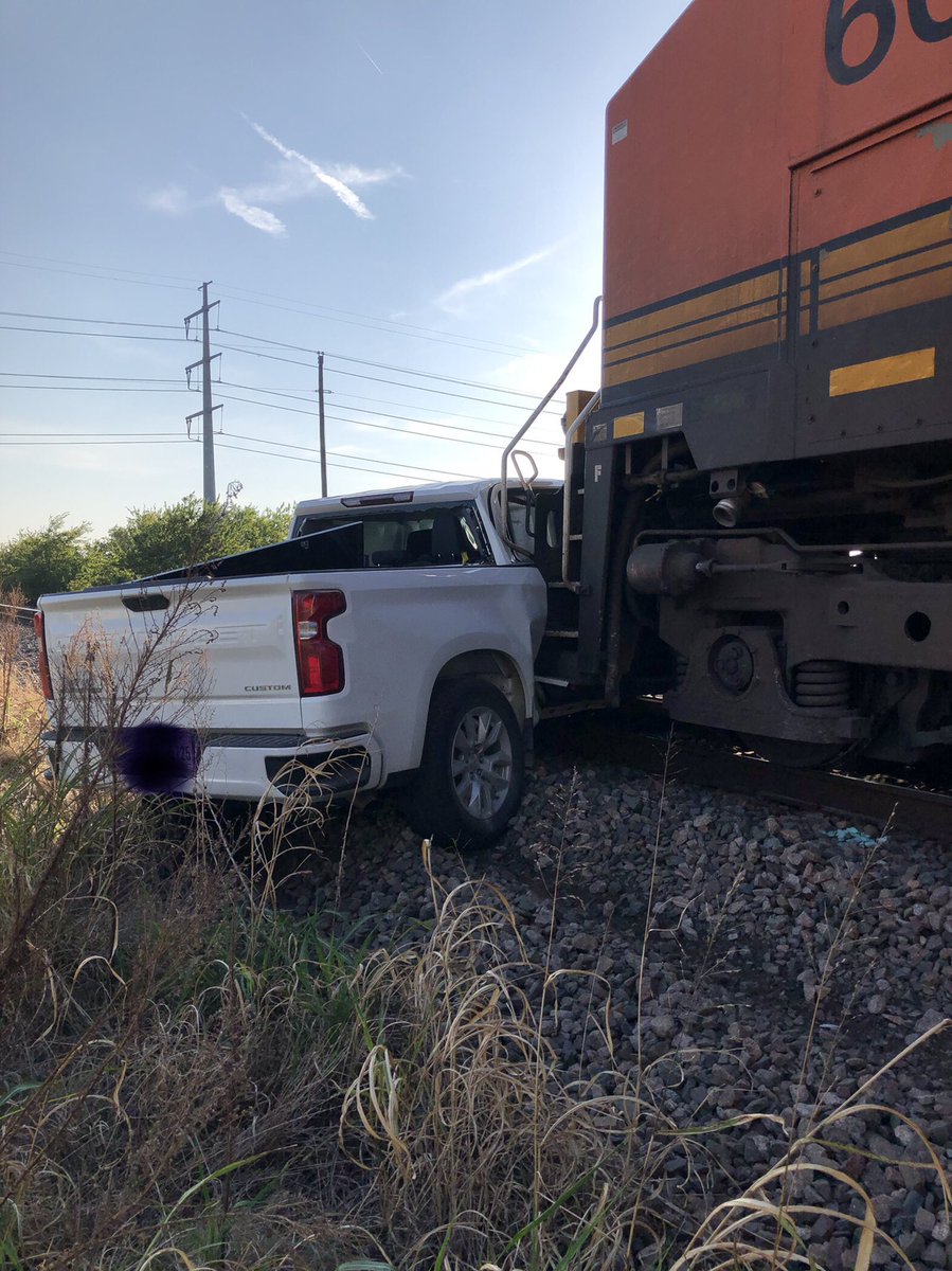 FWFDLT's tweet photo. Don’t try crossing the tracks in any random place, you may get stuck!!Luckily the train was only going 18mph when they hit. Still drug the truck about 200 feet. No one was hurt.  Happened in NW Ft. Worth. @DFWscanner https://t.co/vbkLNtNl8M