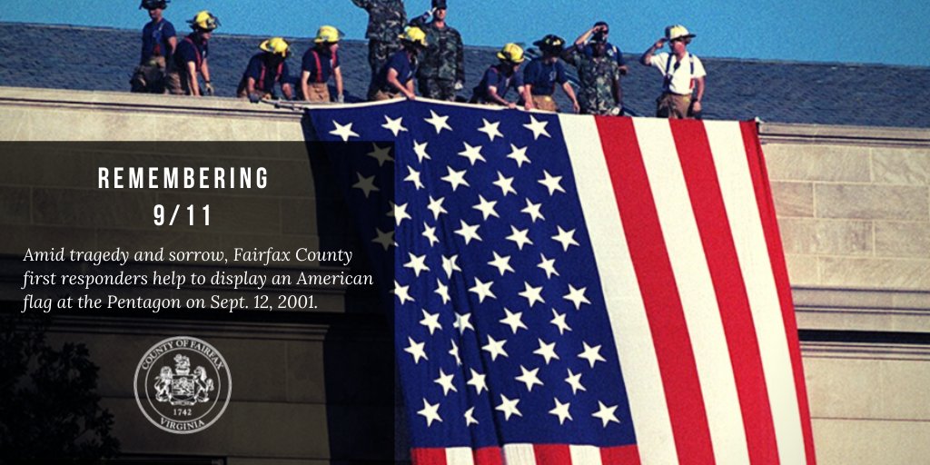 Fairfax County  first responders help to display an American  flag at the Pentagon on Sept. 12, 2001.