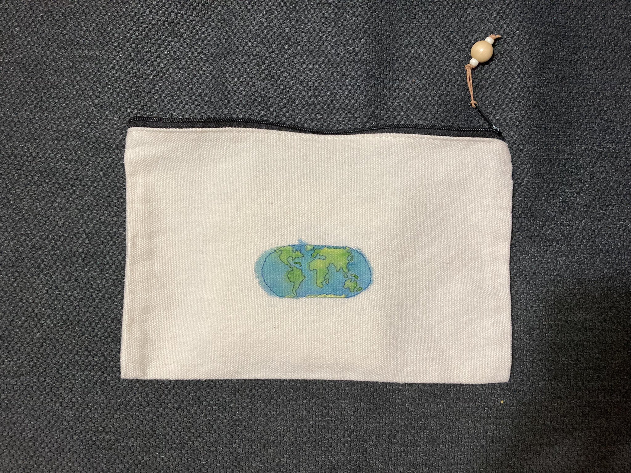 Small canvas pouch with a world map embroidered and painted