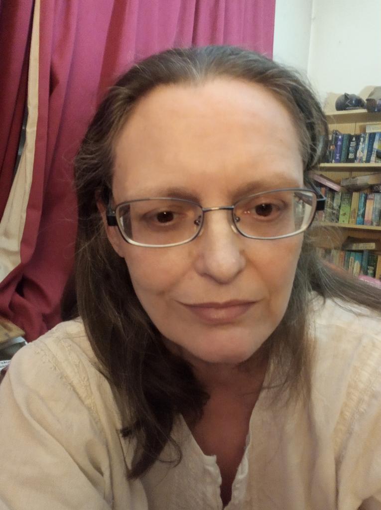 I've never tweeted a selfie before but I'm so pleased to have got my glasses sorted out I'm going for it. Here are the only frames in the whole opticians that my lenses fit in. I was so relieved! You can see how strong they are by how much they distort the width of my face.