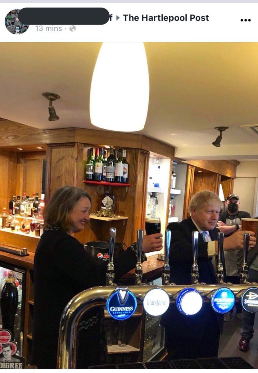 The man who made it illegal in England to drink standing up inside a pub and mandates a mask to walk through the inside of a pub is pictured today drinking standing up inside a pub and not wearing a mask.