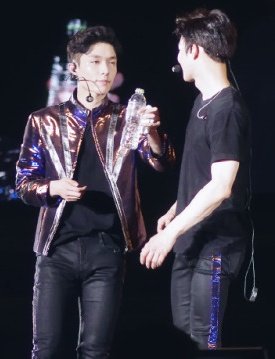  yixing taking care of junmyeon in small ways like handing him a water bottle or tissues after they perform.