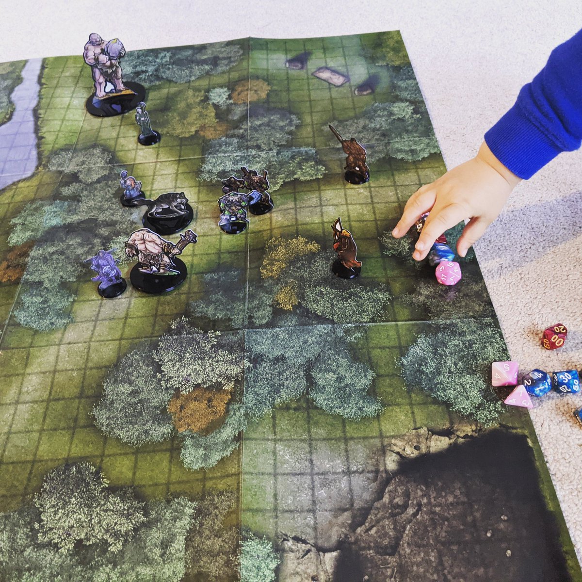 Busted out the <a href="/geektankgames/">Geek Tank Games</a> minis to see how they look on a battlemap if/when I ever get to DM in person with real people again.
(Canada vaccine rollout has been slow)
Our three year old was super into it with his big, chunky, peanut butter hands. Kid loves d20's.

#ttrpg #dnd