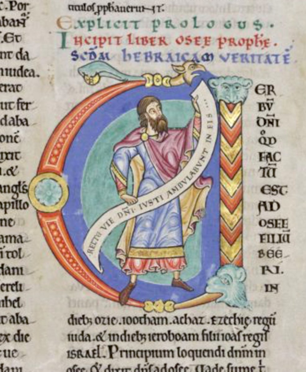 Historiated initial 'V'(erbum) at the beginning of Hosea depicting Hosea holding a scroll in his hands: 'Recte vie domini iusti ambulabunt in eis'. #MS003TheDoverBibleCambridge, Corpus Christi College, MS 003; The Dover Bible, Volume I; 12th century; f.255r  @ParkerLibCCCC