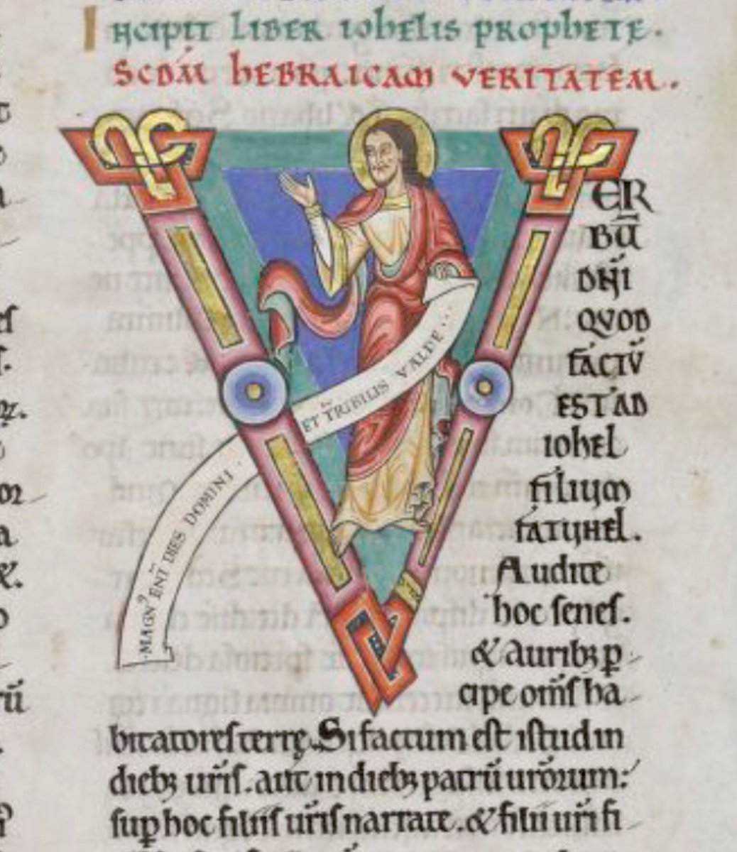 Initial 'V'(erbum) at the beginning of Joel depicting Joel holding a scroll on which is written:'Magnus enim dies domini et terribilis valde'. #MS003TheDoverBibleCambridge, Corpus Christi College, MS 003; The Dover Bible, Volume I; 12th century; f.258r  @ParkerLibCCCC