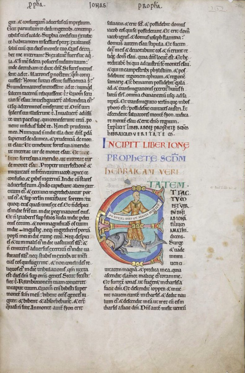 Initial 'E'(t) depicts a bald Jonah holding a scroll: 'Adhuc XL dies et Ninive subvertetur'. Below his feet Jonah's head protrudes from a fish's mouth. #MS003TheDoverBible Cambridge, Corpus Christi College, MS 003; The Dover Bible, Volume I; 12th century; f.262r  @ParkerLibCCCC
