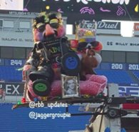 RBB is reading the bibliography of Bette Davis (google is your friend)Start paying attention to the blue and green smiley faces now, RBB's crown has a green jewel facing forward too.