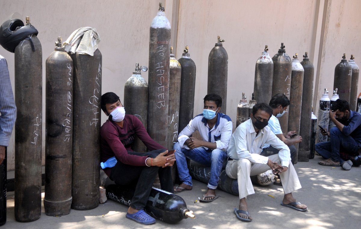 People wait with empty cylinders to refill with medical oxygen at Talkatora oxygen plant on Monday in Lucknow, India.  Deepak Gupta / Getty