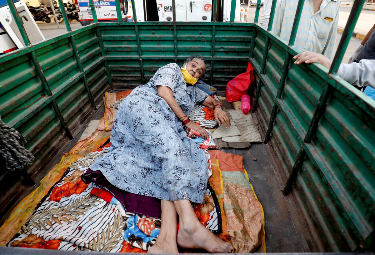 A woman lies in the back of a load carrier waiting to enter a COVID-19 hospital for treatment in Ahmedabad, India, on Monday. Amit Dave / Reuters