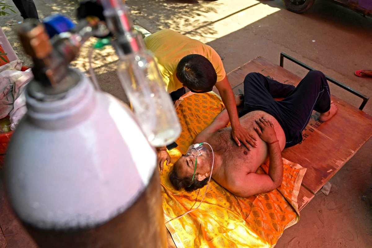 A patient breathes with the help of oxygen provided by a Gurdwara, a place of worship for Sikhs, under a tent installed along the roadside amid Covid-19 coronavirus pandemic in Ghaziabad, India. Sajjad Hussain / AFP