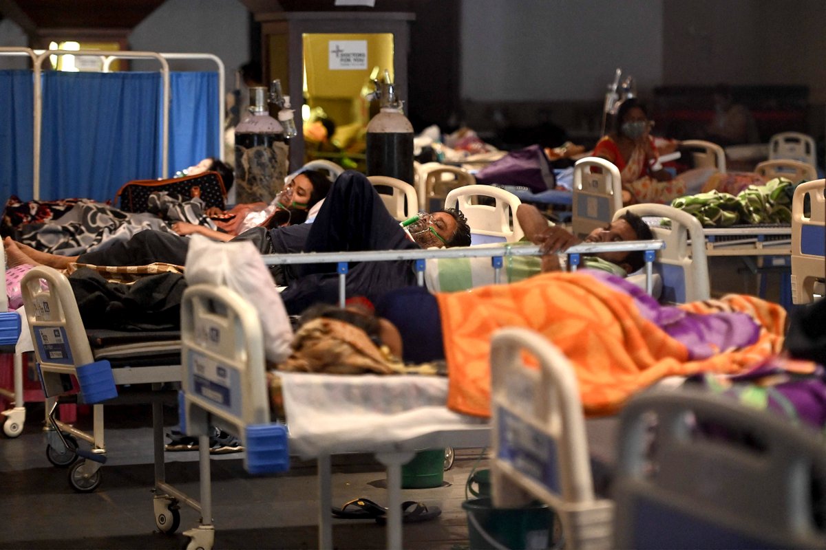 Patients breath with the help of oxygen masks inside a banquet hall temporarily converted into a coronavirus ward in New Delhi on Tuesday Money Sharma / AFP