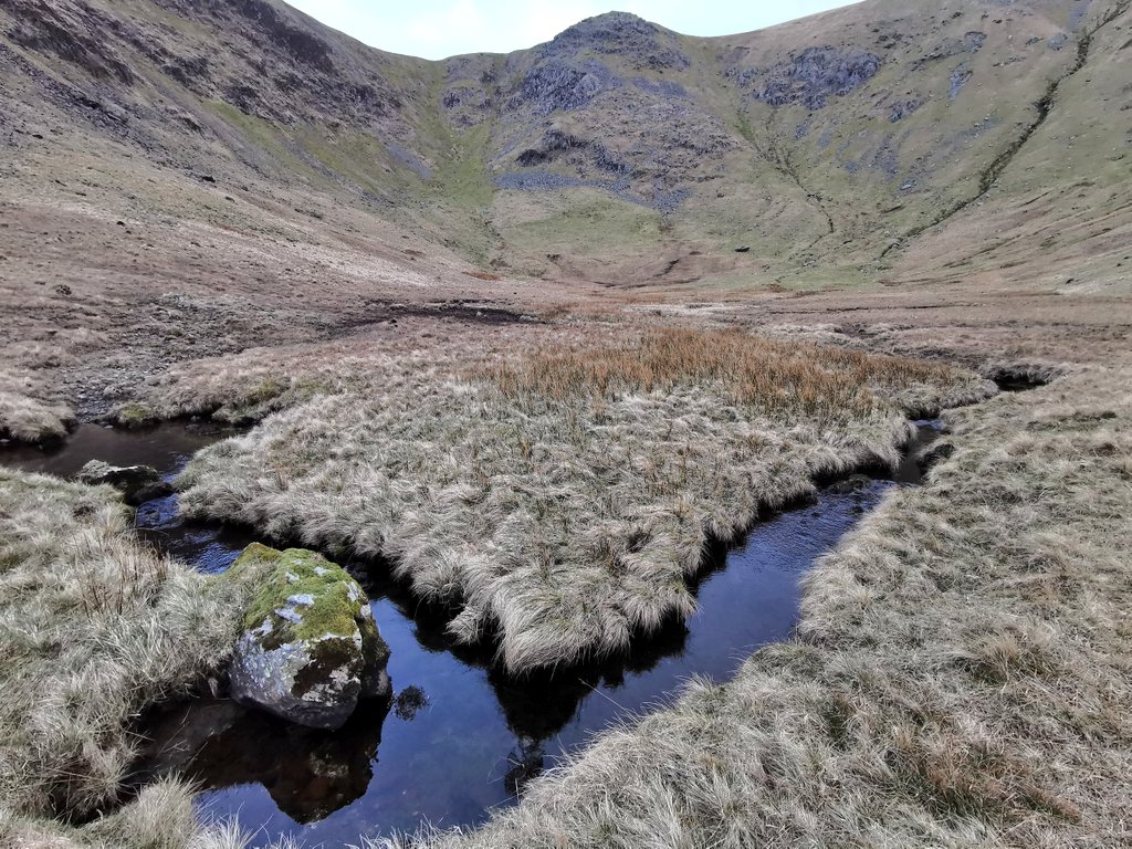 The centre of the corrie is definitely lower than the lip at it's entrance, and it's always a surprise to crest it and find there's no open water, other than in the network of drains that flow through its boggy bottom.
