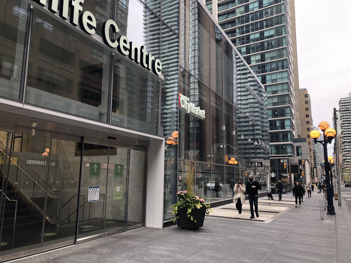 At 6:45PM, after finishing buying groceries with a friend at CityMarket in Manulife Centre (below), we were walking up the stairs to the exit. While we were coming up the stairs, a lady - white, blonde, ponytail, wearing a vest - was walking down. 2/