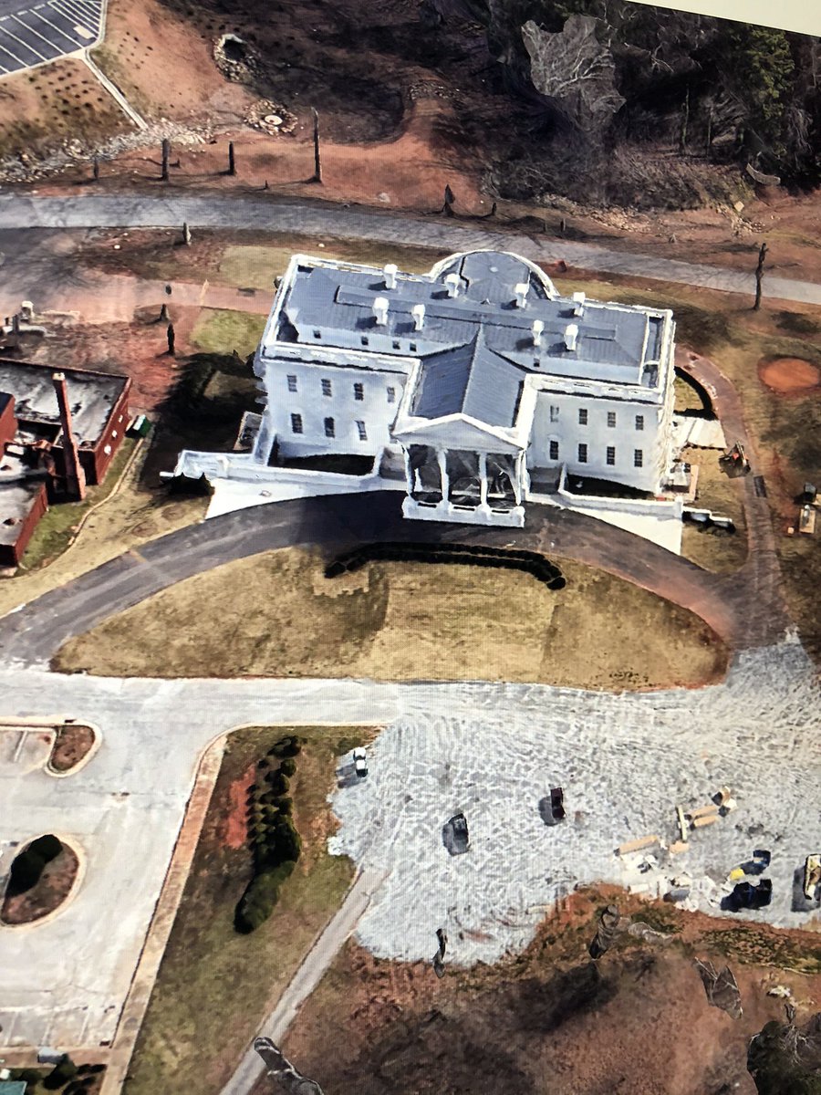 First image is of the building at fort McPherson. Same number of windows. Same green arched hedge. Same number of vents on the roof. Same circular design on the roof, at the back of the building. Same white rectangular canopy at the back of the building.