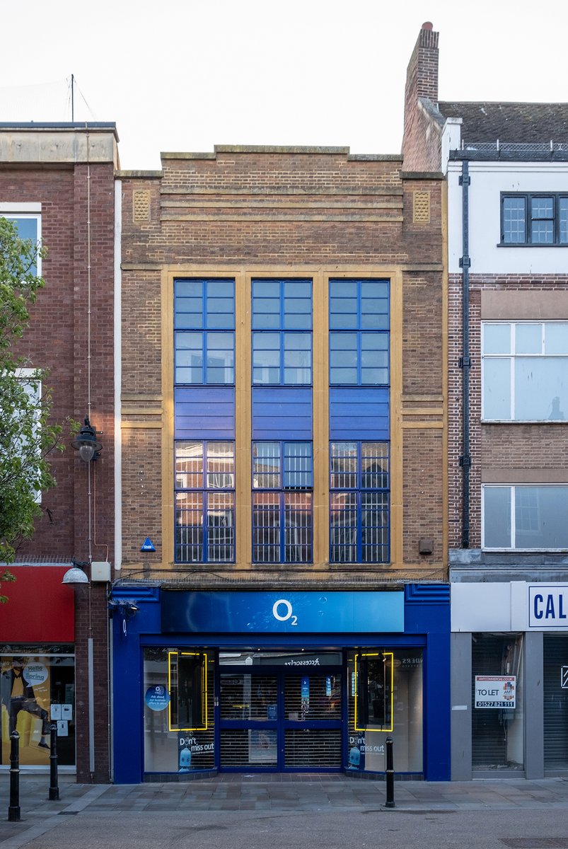 Further down the High Street is the O2 store. Originally one of four identical mid-'30s retail units, though only two now survive, this being the best preserved.Opposite is the 1936 branch of Boots, designed by Percy J. Bartlett, complete with a pair of flag poles.