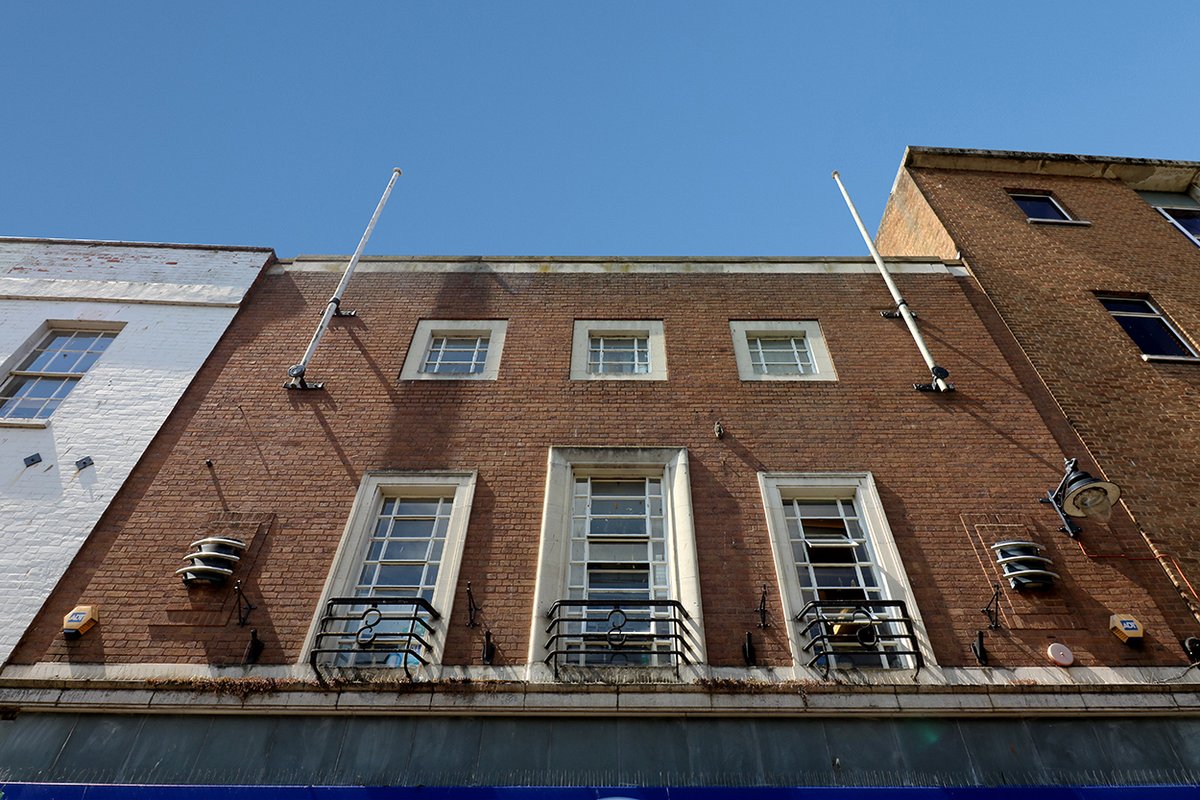Further down the High Street is the O2 store. Originally one of four identical mid-'30s retail units, though only two now survive, this being the best preserved.Opposite is the 1936 branch of Boots, designed by Percy J. Bartlett, complete with a pair of flag poles.