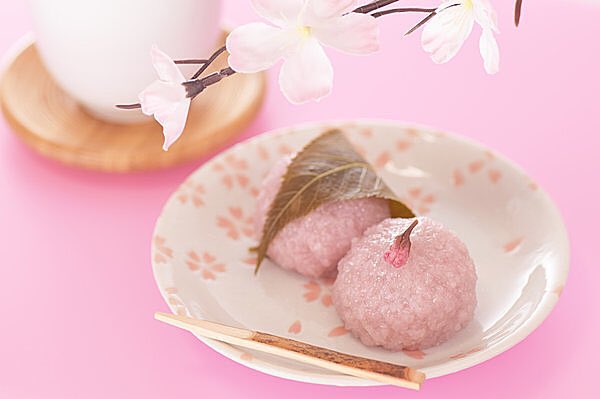 Morever, sakura mochi or something of that type is considered to be ocha gashi, something to eat with tea. This is why many wagashi are quite sweet - the sweetness counteracts the bitterness of the tea. Here are some stock photos of sakura mochi that clearly show them w/tea.