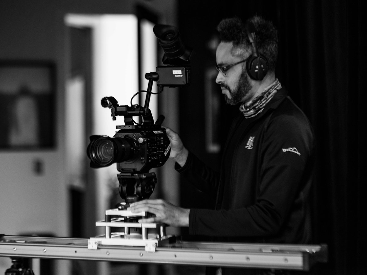 Ah, the slider. Video editor, Jason, who doubles as a cam op is setting the stage to use this bad boy. The slider comes in handy to get the camera moving smoothly. A great way to change up content &amp; add dynamic shots to the final product. #filmcrew dragonflystories.tv/capabilities/